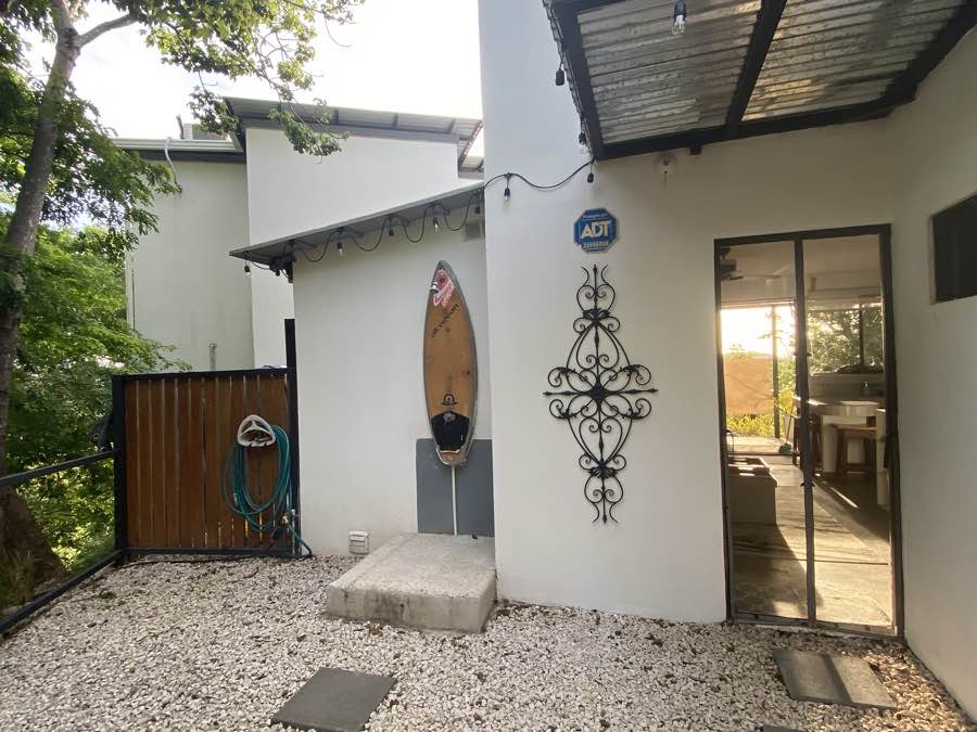 The garden-floor patio at Casa Luna, sliding doors open to the living room