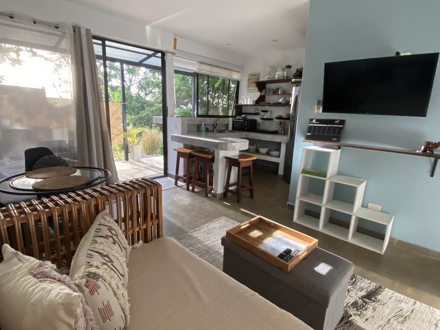The open living room and kitchen at Casa Luna, opening to the garden