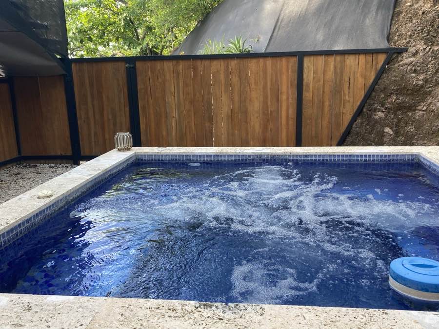 The private jacuzzi at Casa Luna with the jets running, wrapped in a teak privacy fence