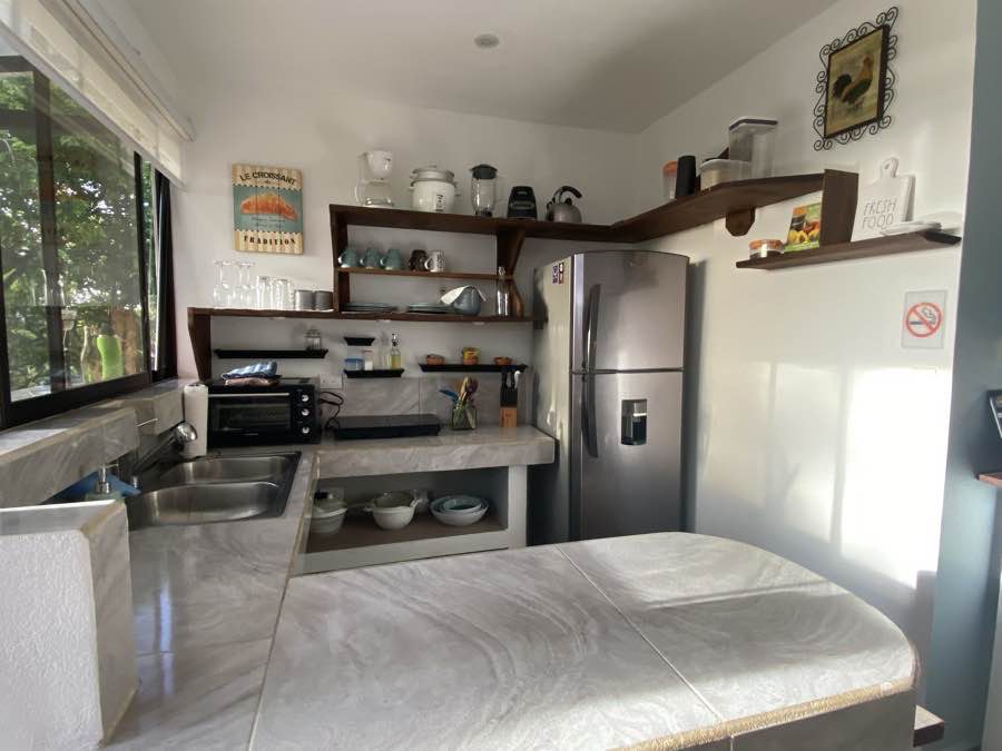 The full kitchen at Casa Luna, marble counters and open shelving
