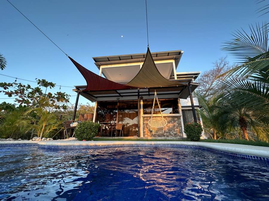 The pool and shade sails below the villa at Casa Sol
